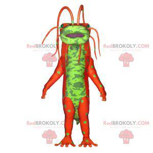 Mascota monstruo insecto verde y naranja con antenas -