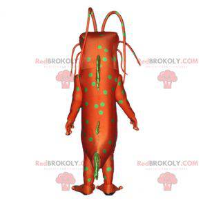 Mascota monstruo insecto verde y naranja con antenas -