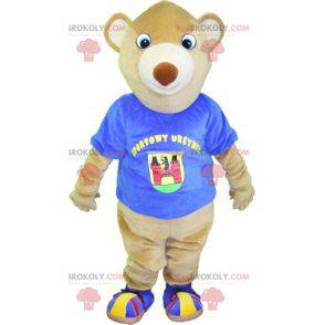 Mascot beige bear with a blue t-shirt. Teddy bear mascot -