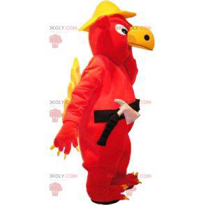 Mascotte grifone rosso e giallo con un casco e strumenti.