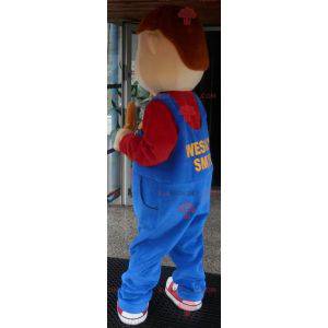 Jonge lachende jongen mascotte gekleed in overall -