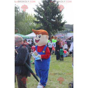 Mascota muchacho sonriente joven vestida con un mono -