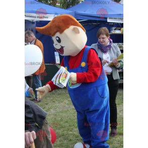 Mascotte de jeune garçon souriant habillé d'une salopette -