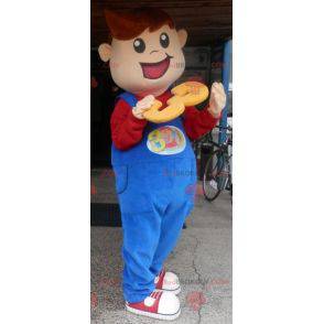 Menino mascote sorridente vestido de macacão - Redbrokoly.com