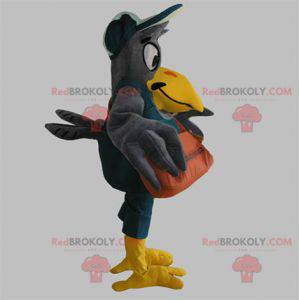 Mascot pájaro gigante gris y amarillo con una bolsa -