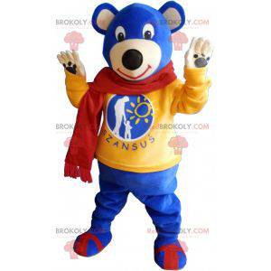 Mascotte d'ourson bleu portant une écharpe rouge -