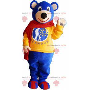 Mascotte d'ourson bleu portant une écharpe rouge -