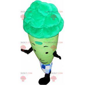 Mascota de espárragos verdes gigantes rodeada por un papel