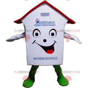 Mascote de casa branca vermelha e verde muito sorridente -