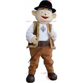 Snowman mascot in shepherd outfit with bowler hat -