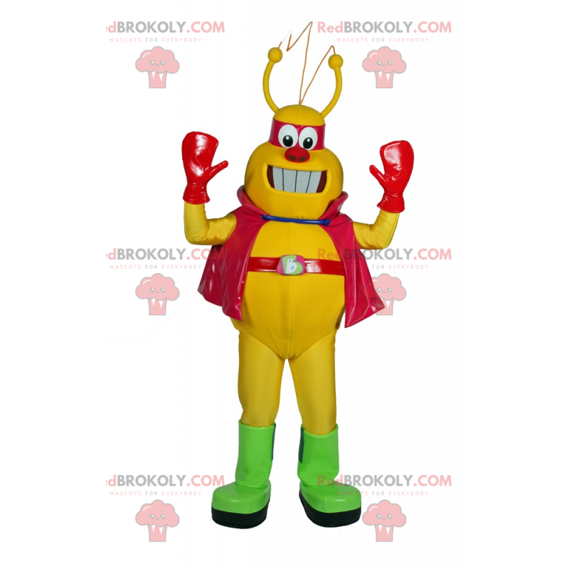 Mascota alienígena amarilla con capa - Redbrokoly.com