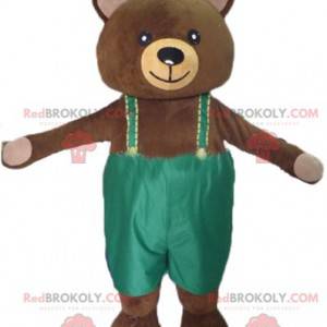 Mascotte de gros nounours marron avec une salopette verte -