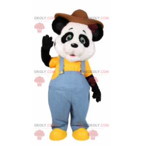 Mascotte de panda en salopette bleu et chapeau marron -