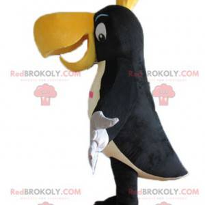 Mascotte de toucan noir blanc et jaune avec une couronne -