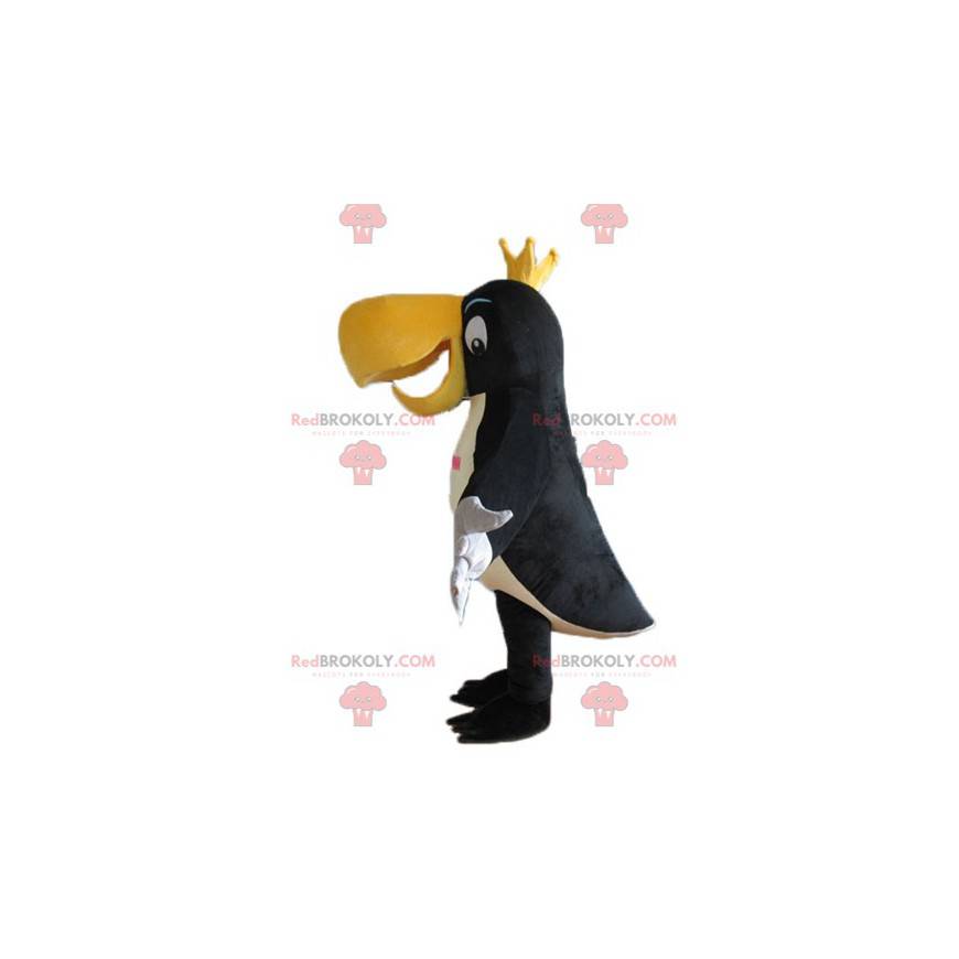 Schwarzes weißes und gelbes Tukanmaskottchen mit einer Krone -
