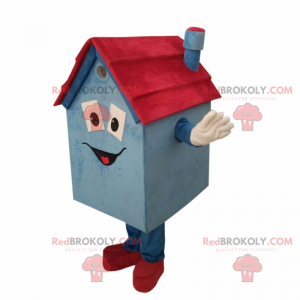 Mascotte piccola casa blu e rossa con un sorriso -