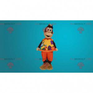 Brown monkey mascot dressed in orange outfit - Redbrokoly.com