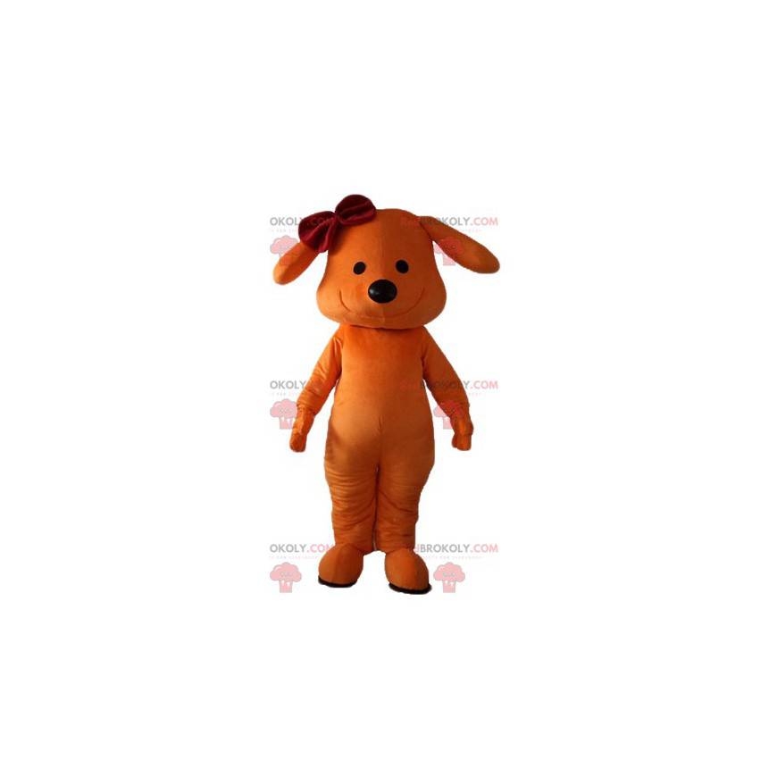 Oranje hond mascotte lachend met een strik op zijn hoofd -