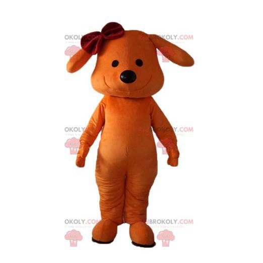 Mascote cachorro laranja sorrindo com um arco na cabeça -