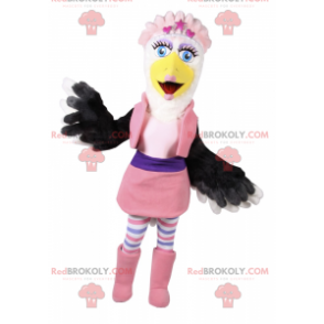 Mascota pájaro blanco y negro en traje de glamour rosa -