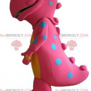Grande mascote de dinossauro rosa e amarelo com pontos azuis -