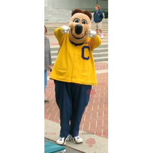Mascotte d'ours brun en tenue de sport jaune et bleue -