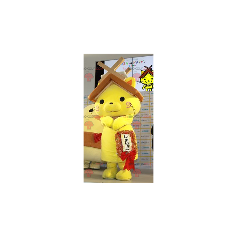 Yellow cat mascot with a house roof on the head - Redbrokoly.com