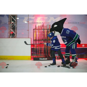 Mascotte d'orque noir et blanc en tenue de hockey -