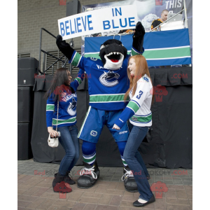 Black and white killer whale mascot in hockey gear -