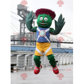 Mascotte d'artichaut vert et rouge en tenue bleue et jaune -