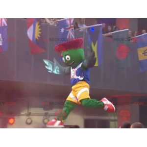 Green and red artichoke mascot in blue and yellow outfit -