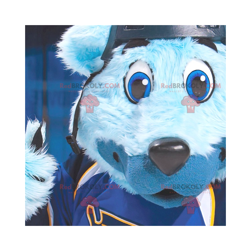 Mascotte blauwe beer met blauwe ogen in sportkleding -