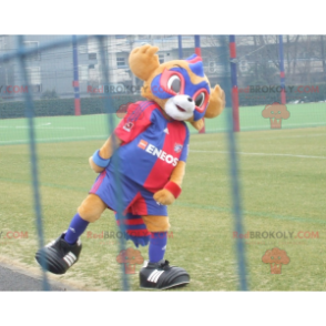 2 mascots: a yellow bear and a blue and red masked animal -