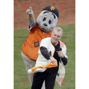 Gray sea lion mascot with an orange t-shirt - Redbrokoly.com