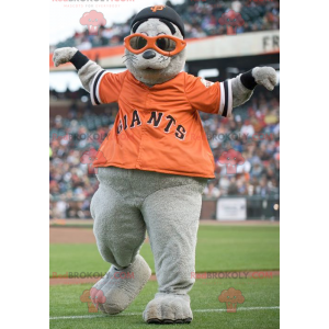 Gray sea lion mascot with an orange t-shirt - Redbrokoly.com