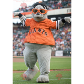 Gray sea lion mascot with an orange t-shirt - Redbrokoly.com