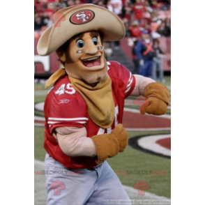 Mascotte del cowboy muscoloso e sorridente - Redbrokoly.com