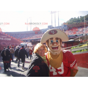 Mascotte del cowboy muscoloso e sorridente - Redbrokoly.com