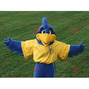 Mascote pássaro azul e amarelo em roupas esportivas -