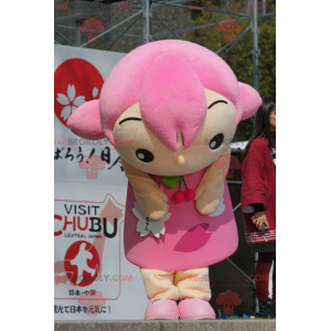 Mascotte de fillette avec les cheveux et une robe rose -