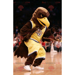 Águia marrom mascote vestida com roupas esportivas amarelas -