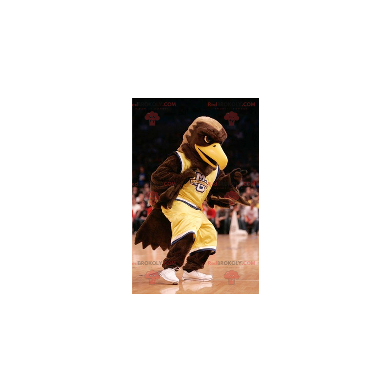 Mascotte d'aigle marron habillé en tenue de sport jaune - Mascotte d'aigle marron habillé en tenue de sport jaune -