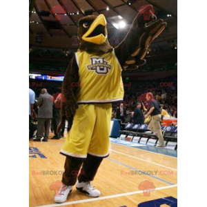 Brown eagle mascot dressed in yellow sportswear - Redbrokoly.com