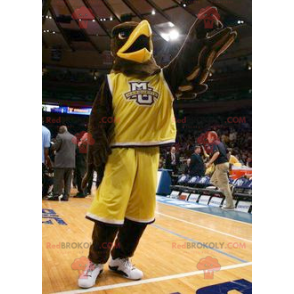 Mascotte d'aigle marron habillé en tenue de sport jaune -