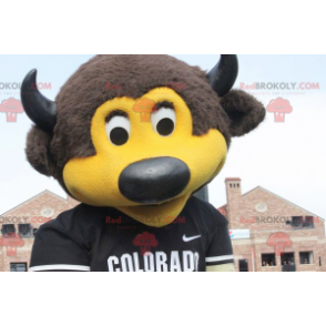 Brown and yellow bear mascot with horns and a jersey -