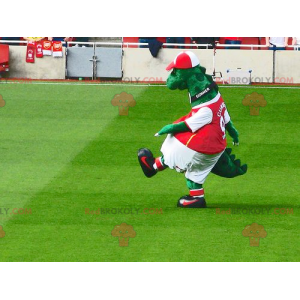 Green dinosaur mascot in red and white sportswear -