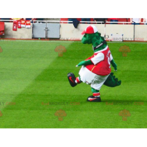 Green dinosaur mascot in red and white sportswear -