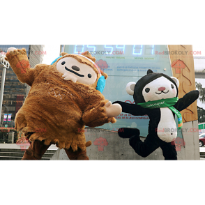 2 mascotes, um yeti marrom e um macaco preto e branco -