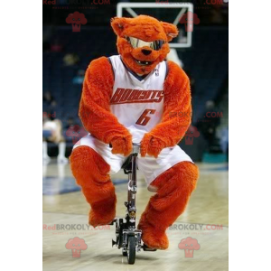 Orange bear mascot with glasses in basketball outfit -