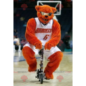 Orange bear mascot with glasses in basketball outfit -